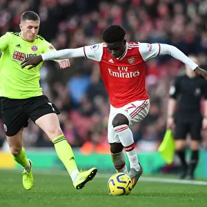 Intense Battle: Bukayo Saka vs. John Lundstram - Arsenal's Clash Against Sheffield United