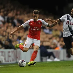 Intense Battle: Debuchy vs Chadli in the Capital One Cup Clash between Tottenham and Arsenal Intense Battle: Debuchy vs Chadli in the Capital One Cup Clash between Tottenham and Arsenal