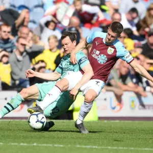 Intense Battle: Lichtsteiner vs. Gudmundsson - Premier League Clash between Burnley and Arsenal