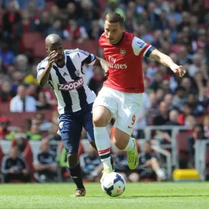 Intense Battle: Lukas Podolski vs Youssouf Mulumbu - Arsenal v West Bromwich Albion, Premier League Intense Battle: Lukas Podolski vs Youssouf Mulumbu - Arsenal v West Bromwich Albion, Premier League