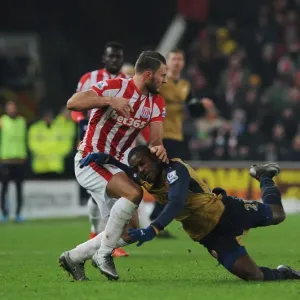 Intense Face-off: Joel Campbell vs. Erik Pieters in Arsenal's Premier League Battle