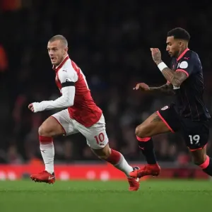 Intense Face-Off: Wilshere vs. Kachunga in Arsenal's Premier League Battle Intense Face-Off: Wilshere vs. Kachunga in Arsenal's Premier League Battle