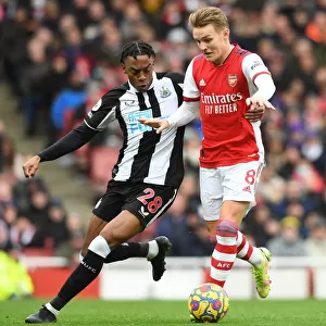 Intense Midfield Rivalry: Odegaard vs. Willock at Emirates Stadium - Arsenal vs. Newcastle United (2021-22)