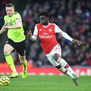 Intense Rivalry: Bukayo Saka vs. John Lundstram - Arsenal's Battle Against Sheffield United