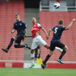 Intense Rivalry: Craig Eastmond's Leap Over Molina and O'Connell during Arsenal U21s vs Blackburn Rovers Intense Rivalry: Craig Eastmond's Leap Over Molina and O'Connell during Arsenal U21s vs Blackburn Rovers