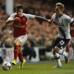Intense Rivalry: Debuchy vs. Eriksen in the Capital One Cup Showdown between Arsenal and Tottenham Intense Rivalry: Debuchy vs. Eriksen in the Capital One Cup Showdown between Arsenal and Tottenham