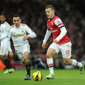 Intense Rivalry: Jack Wilshere vs Leon Britton Clash in the 2012-13 Premier League Intense Rivalry: Jack Wilshere vs Leon Britton Clash in the 2012-13 Premier League