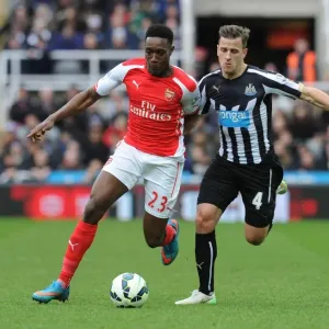 Intense Rivalry: Welbeck vs. Taylor Clash in Newcastle United vs. Arsenal Premier League Match