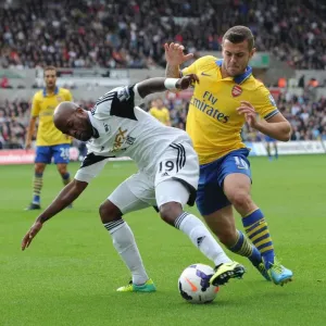 Intense Rivalry: Wilshere vs. Tiendalli - The Battle at Swansea's Liberty Stadium Intense Rivalry: Wilshere vs. Tiendalli - The Battle at Swansea's Liberty Stadium