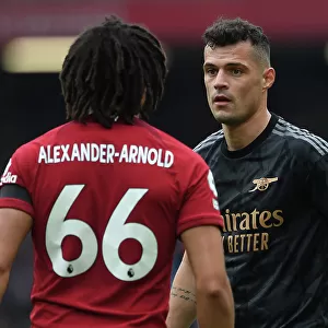 Intense Rivalry: Xhaka vs. Alexander-Arnold - A Battle of Wits at Anfield, Premier League 2022-23: Granit Xhaka and Trent Alexander-Arnold Lock Horns in Epic Showdown