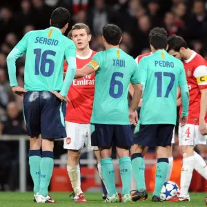 Jack Wilshere (Arsenal) chats to Sergio Busquets and Xavi (Barcelona). Arsenal 2