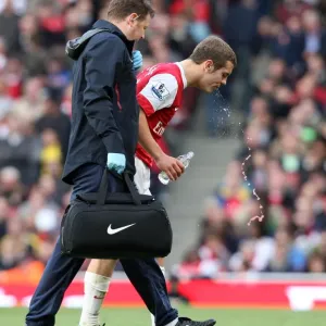 Jack Wilshere (Arsenal) gets treatment for a bloody lip from Physio Colin Lewin