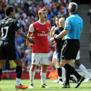 Jack Wilshere (Arsenal) and Nani (Man Utd) talk to Referee Chris Foy. Arsenal 1