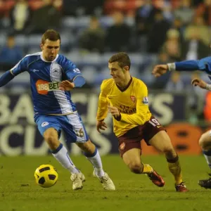 Jack Wilshere (Arsenal) Ronnie Stam and James McArthur (Wigan). Wigan Athletic 2