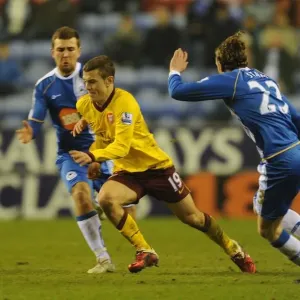 Jack Wilshere (Arsenal) Ronnie Stam (Wigan). Wigan Athletic 2: 2 Arsenal