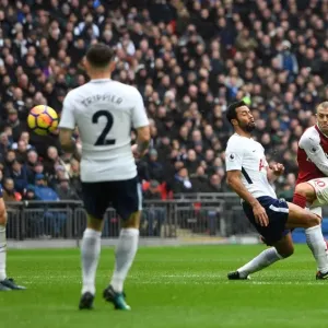 Jack Wilshere (Arsenal) shoots under pressure from Mousa Dembele (Tottenham) Jack Wilshere (Arsenal) shoots under pressure from Mousa Dembele (Tottenham)