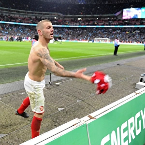 Jack Wilshere (Arsenal) throws his shirt to a fan after the match