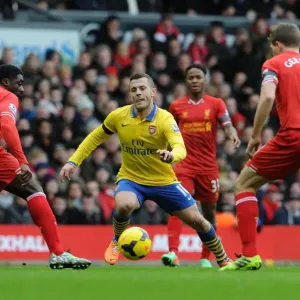 Jack Wilshere Charges Past Kolo Toure and Steven Gerrard in Intense Liverpool vs. Arsenal Clash Jack Wilshere Charges Past Kolo Toure and Steven Gerrard in Intense Liverpool vs. Arsenal Clash