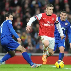 Jack Wilshere Faces Intense Pressure from Gary Medel and Peter Whittingham during Arsenal vs. Cardiff City (2013-14) Jack Wilshere Faces Intense Pressure from Gary Medel and Peter Whittingham during Arsenal vs. Cardiff City (2013-14)
