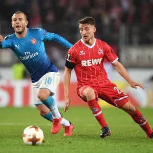 Jack Wilshere Outmaneuvers Salih Ozcan in Arsenal's UEFA Europa League Clash vs. 1. FC Koln Jack Wilshere Outmaneuvers Salih Ozcan in Arsenal's UEFA Europa League Clash vs. 1. FC Koln
