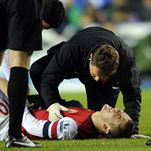 Jack Wilshere Receives Treatment from Arsenal Physio Colin Lewin during Reading vs Arsenal (2012-13)