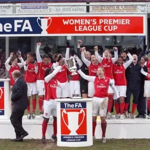Jayne Ludlow and Anita Asante lift the League Cup Trophy for Arsenal