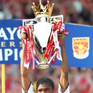 Kanu lifts the F. A. Barclaycard Premiership Trophy