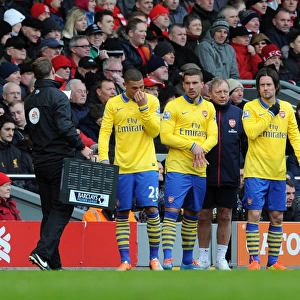 Kieran Gibbs, Lukas Podolski and Tomas Rosicky (Arsenal) prepare to come on as substitutes