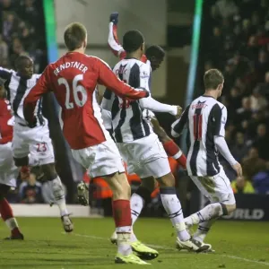 Kolo Toure heads past West Brom goalkeeper Scott Carson