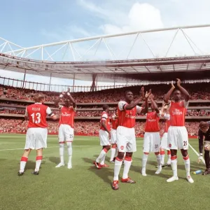 Kolo Toure and Johan Djourou (Arsenal) clap the fans along with the rest of the team