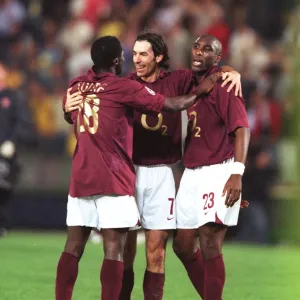 Kolo Toure, Robert Pires and Sol Campbell (Arsenal) celebrate at the end of the match