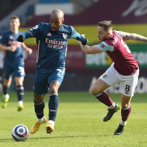 Lacazette vs Brownhill: Empty Turf Moor Clash - Premier League 2020-21: A Battle Between Arsenal's Alexandre Lacazette and Burnley's Josh Brownhill in an Emptied Stadium
