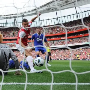 Laurent Koscielny shoots past Bolton goalkeeper Adam Bogdan to score the 1st Arsenal goal Laurent Koscielny shoots past Bolton goalkeeper Adam Bogdan to score the 1st Arsenal goal