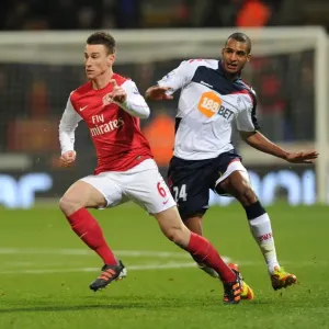 Laurent Koscielny Surges Past David Ngog: Bolton Wanderers vs. Arsenal, Premier League 2011-12 Laurent Koscielny Surges Past David Ngog: Bolton Wanderers vs. Arsenal, Premier League 2011-12