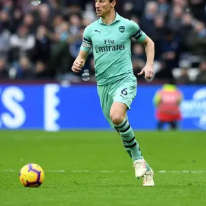 Laurent Koscielny: Unyielding Focus in the Heart of the Premier League Battle (West Ham United vs Arsenal FC, 2019) Laurent Koscielny: Unyielding Focus in the Heart of the Premier League Battle (West Ham United vs Arsenal FC, 2019)