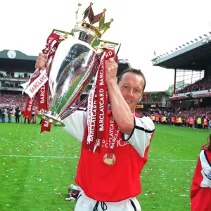 Lee Dixon (Arsenal) lifts the F. A. Barclaycard Premiership Trophy