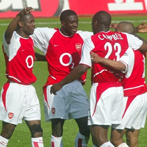 (L>R) Lauren, Kolo Toure, Sol Campbell and Ashley Cole celebrate at the end of the match