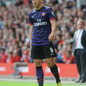Lukas Podolski Faces Off Against Liverpool in the 2012-13 Premier League Lukas Podolski Faces Off Against Liverpool in the 2012-13 Premier League