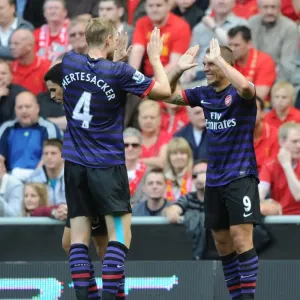 Lukas Podolski and Per Mertesacker Celebrate First Arsenal Goal Against Liverpool (2012-13) Lukas Podolski and Per Mertesacker Celebrate First Arsenal Goal Against Liverpool (2012-13)