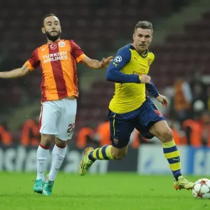 Lukas Podolski Outmaneuvers Olcan Adin: Galatasaray vs. Arsenal, UEFA Champions League, Istanbul, Turkey, 2014 Lukas Podolski Outmaneuvers Olcan Adin: Galatasaray vs. Arsenal, UEFA Champions League, Istanbul, Turkey, 2014