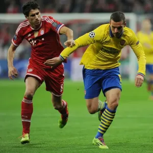 Lukas Podolski vs. Javi Martinez: Battle in the UEFA Champions League between FC Bayern Munich and Arsenal Lukas Podolski vs. Javi Martinez: Battle in the UEFA Champions League between FC Bayern Munich and Arsenal