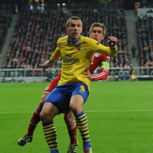 Lukas Podolski vs. Philippe Lahm: A Battle in the UEFA Champions League Round of 16 Lukas Podolski vs. Philippe Lahm: A Battle in the UEFA Champions League Round of 16