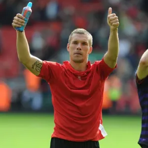 Lukas Podolski's Triumphant Salute: Liverpool vs. Arsenal, Premier League 2012-13 Lukas Podolski's Triumphant Salute: Liverpool vs. Arsenal, Premier League 2012-13