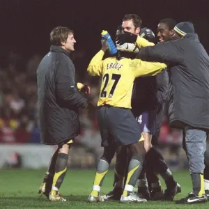 Manuel Almunia celebrates with his team mates (L>R) Arturo Lupoli, Emmanuel Eboue