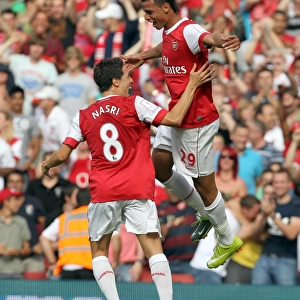 Marouane Chamakh celebrates scoring Arsenals goal with Samir Nasri