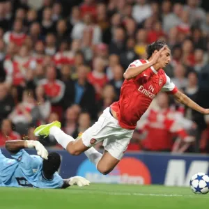 Marouane Chamakh is tripped by Braga goalkeeper Felipe for the Arsenal penalty