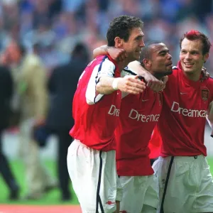 Martin Keown, Ashley Cole and Fredrik Ljungberg celebrate after the match