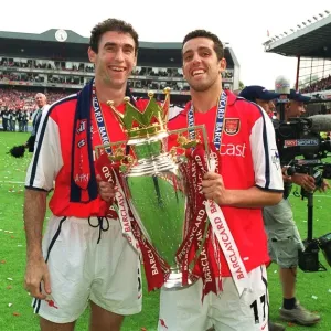 Martin Keown and Edu lift the F. A. Barclaycard Premiership Trophy
