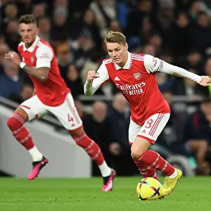 Martin Odegaard in Action: A Riveting Moment from the Arsenal vs. Tottenham Premier League Clash, 2022-23