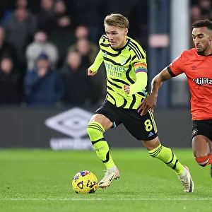 Martin Odegaard Faces Pressure from Jacob Brown in Luton Town vs Arsenal Premier League Clash (2023-24)